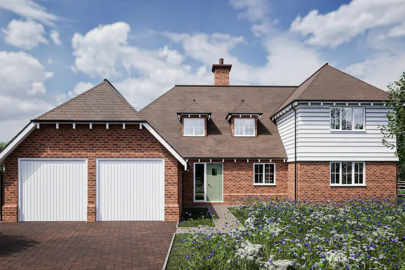 Red block paved driveway in front of a brick house with a double garage