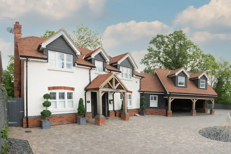 Large English house with a wide, smooth aggregate driveway